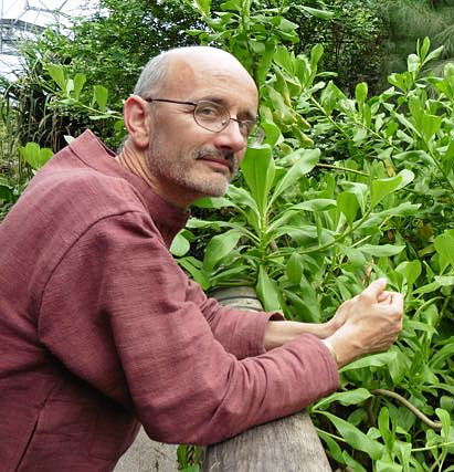 Tomas Remiarz kneeling in front of plants at The Eden Project