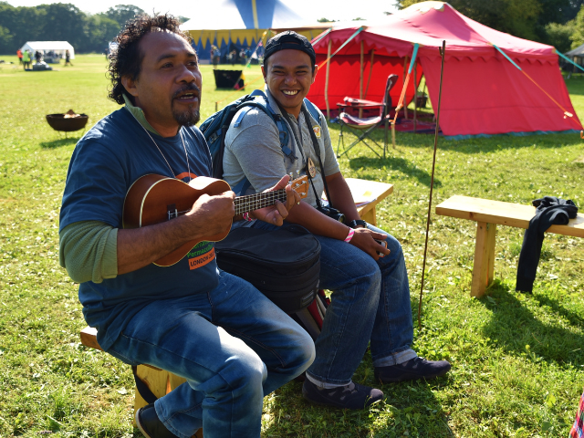 men playing music in a field