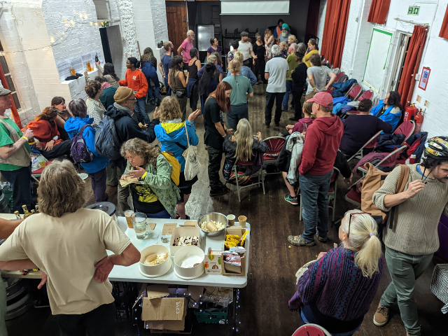 people in a hall at permaculture festival