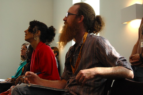 Participants at a conference sit and listen to a speaker