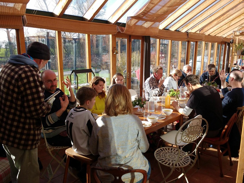 People having lunch around a table at the Hockerton Housing Project