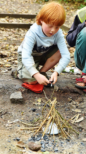 Lighting a campfire to cook snacks for the group