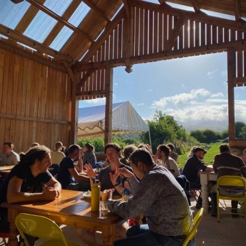 Image of people enjoying lively discussion in a beautiful barn