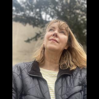 Karen gazing at a birds at a feeder