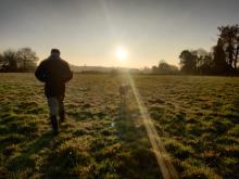 glen walking in a field in winter
